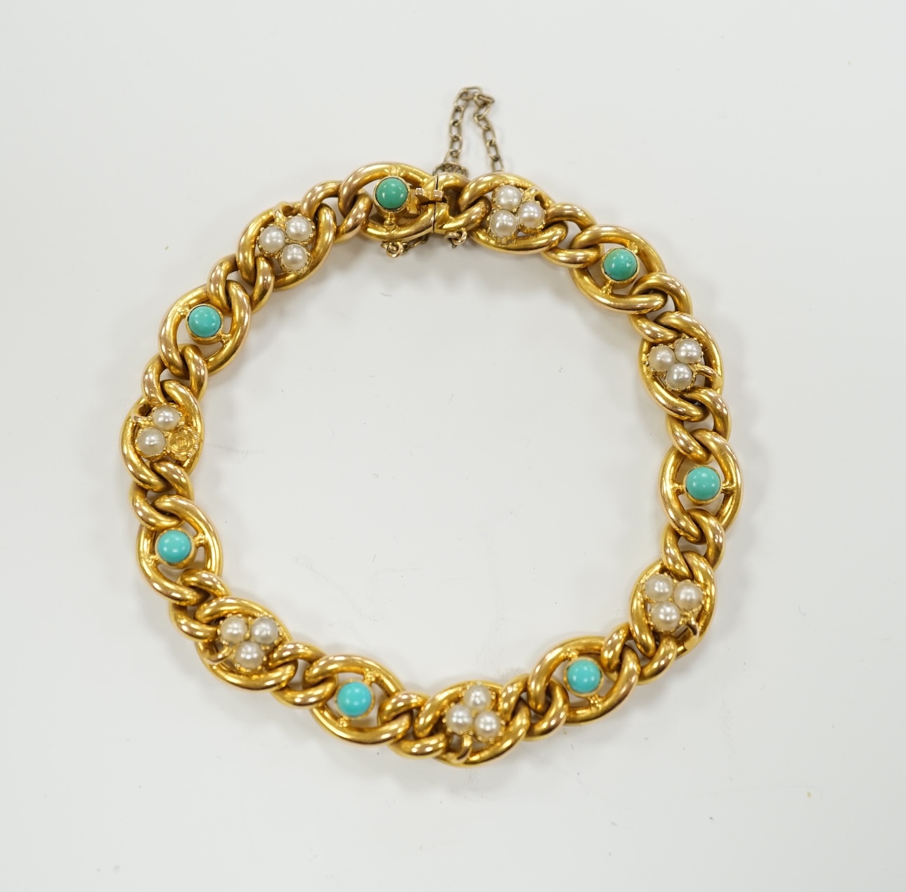 An Edwardian yellow metal (stamped 15), seed pearl cluster and turquoise bead set curb link bracelet, 18cm, gross weight 16.2 grams.